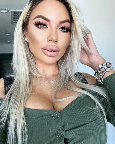 Sasha at home in a green knit.