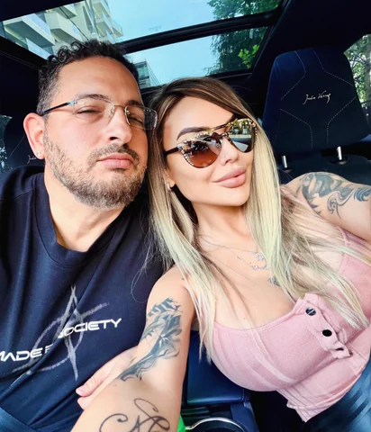 Sasha and her husband in sunglasses, side by side.