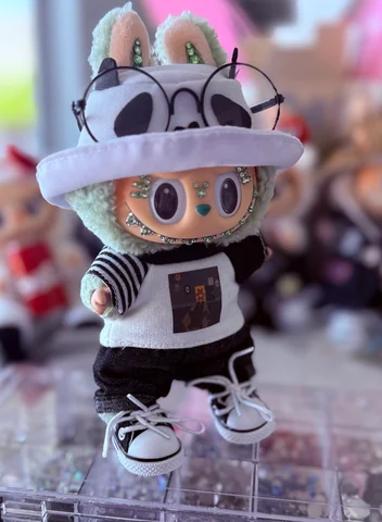 Labubu Nº 07: white panda bucket hat with round glasses, striped sleeves and a graphic tee.