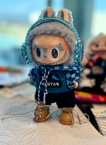 Labubu Nº 09: the blue hoodie look with crystal headphones and laced boots.