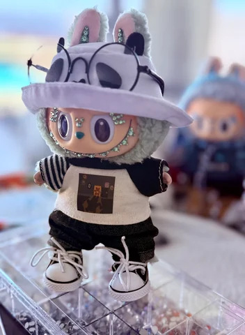 Labubu Nº 15: the panda bucket hat and glasses with a striped tee, seen from the side.