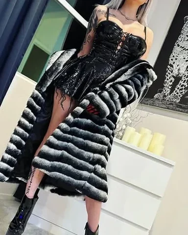 A striped faux fur coat over a black corset.